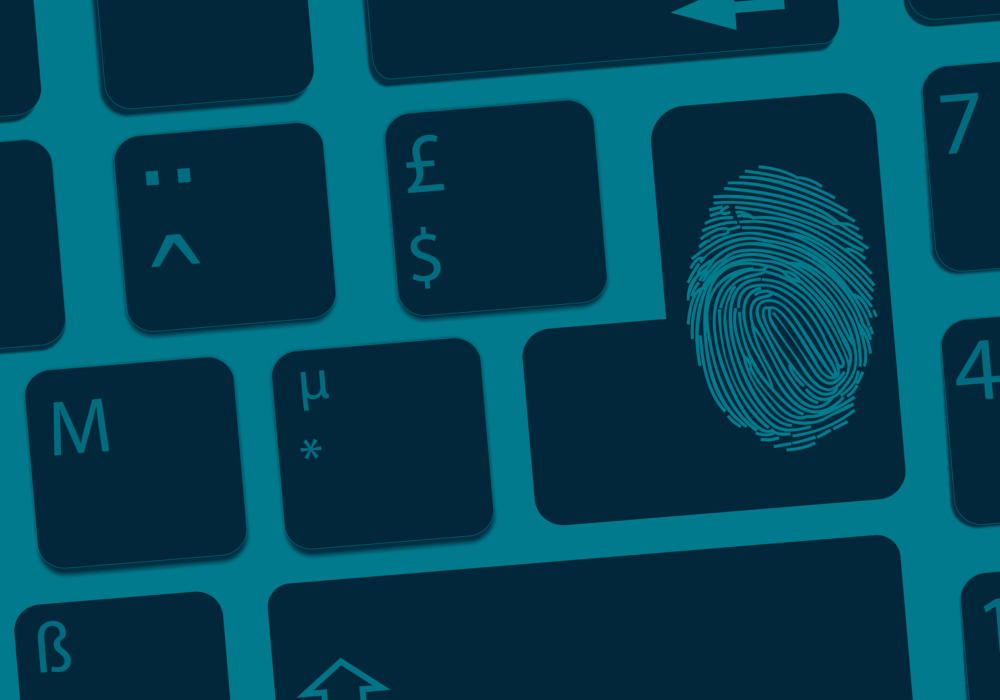 Fingerprint on a digital keyboard symbolising personal cyber insurance against cyber crime and stolen identity.